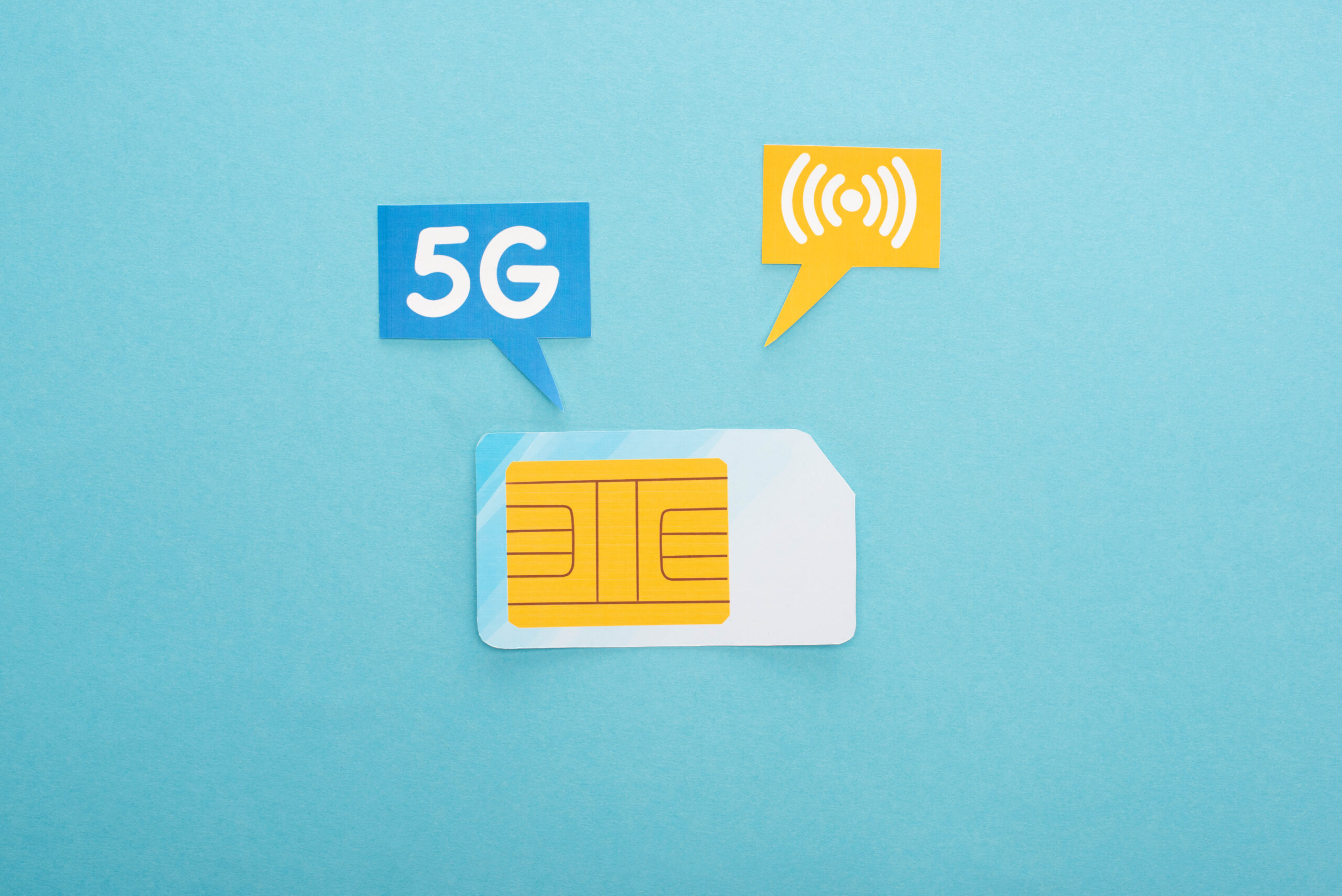 top view of sim card and  speech bubbles with 5g lettering on blue background